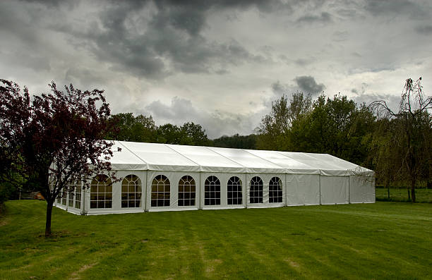 istock Large white marquee on a green lawn on an overcast day 149067973
