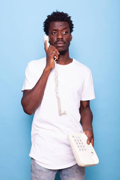 istock Young adult answering retro telephone with wire 1490680936