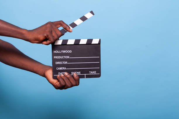 istock Close up of hand holding clapperboard in studio 1490681128