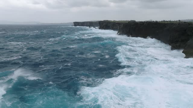 Tropical Waves crashing into the rocks of a cape.