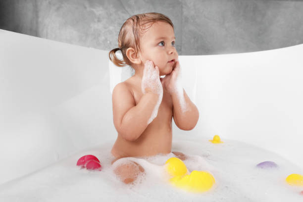 istock Cute little girl taking bubble bath with toys indoors 1490683081