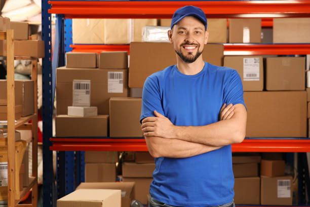 istock Post office worker near rack with parcels indoors, space for text 1490683190