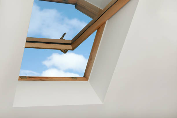 istock Open skylight roof window on slanted ceiling in attic room, low angle view 1490683212
