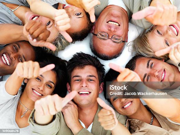 Happy Business Colleagues Showing Thumbs Up Sign Stock Photo - Download Image Now - Large Group Of People, Thumbs Up, 20-24 Years