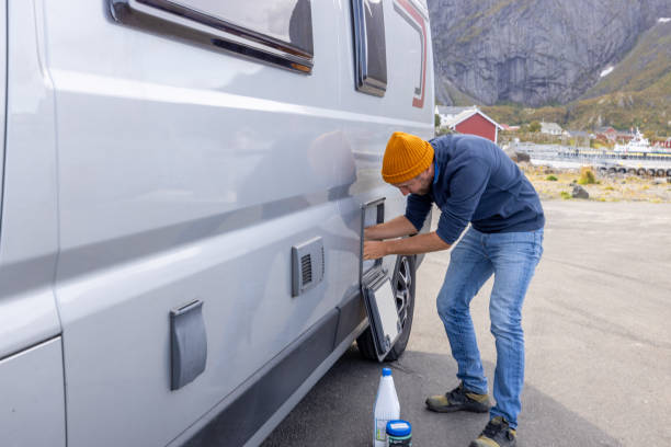 istock Man emptying van tank toilet cassette in dump station 1490685444
