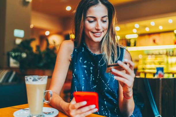 istock Woman in cafe making online payments 1490687958