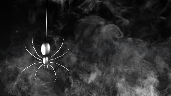 Metallic Spider Swinging on Web with Smoke features a metallic spider swinging from a web and smoke rising.