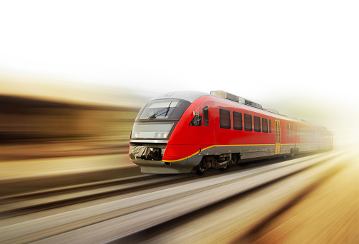 High speed passenger train with motion speed is passing railroad platform