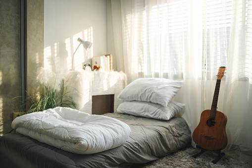 Photo of teenage minimal bedroom, Stylish minimalist comfortable bedchamber in the morning.