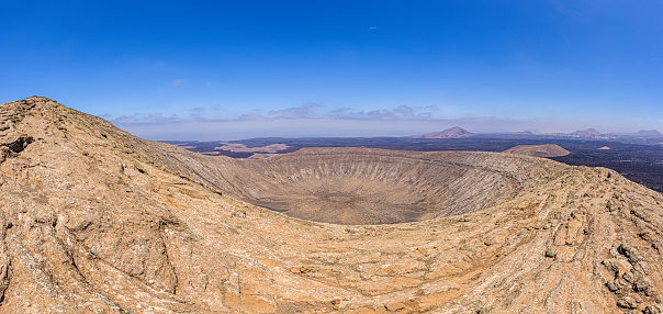 Panoramic view over the volcanic crater of Caldera Blanca on Lanzarote during daytime