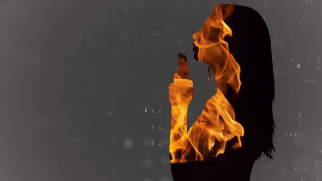 Silhouette of a young adult woman making a gun gesture with her fingers on a gray background with moving double exposure target points in a burning flame. Cg