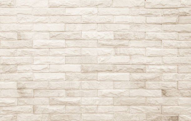 istock Empty background of wide cream brick wall texture. Beige old brown brick wall concrete or stone textured, wallpaper limestone abstract. Cream and white brick wall. Brickwork flooring pattern design. 1490695868