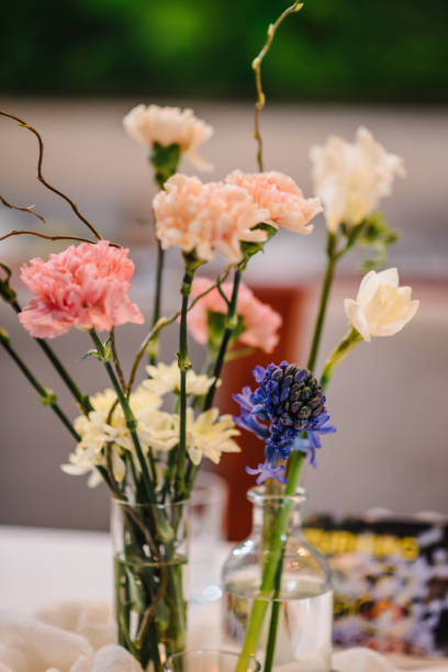istock Decor of flowers, greenery and candles. Luxury elegant table setting dinner in a restaurant. Selective focus. Preparation, decorating of banquet table for a birthday party. Wedding reception. Closeup. 1490697778
