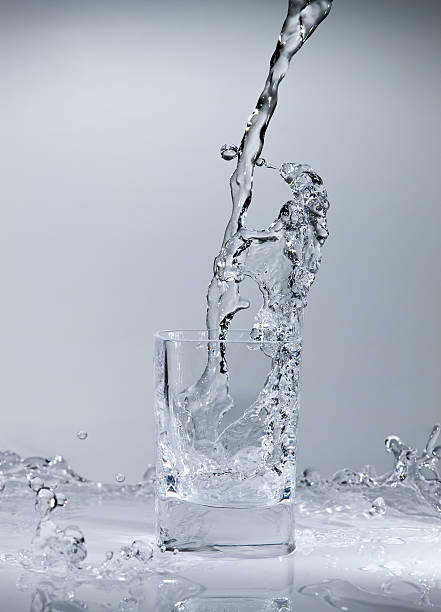 Glass of pouring water stock photo