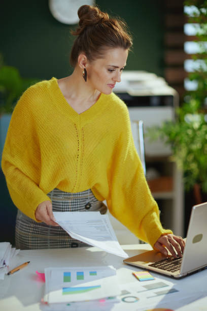 istock business owner woman in green office working with documents 1490700493
