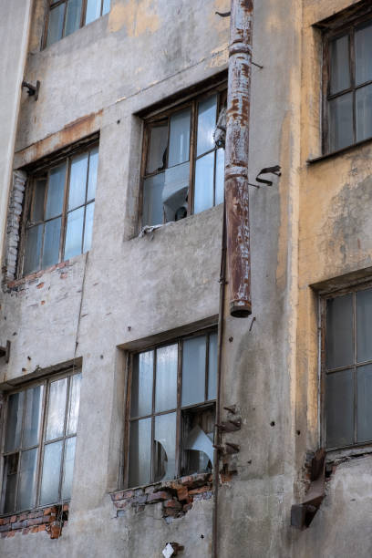 istock Shattered  windows on abandoned industrial building 1490703182