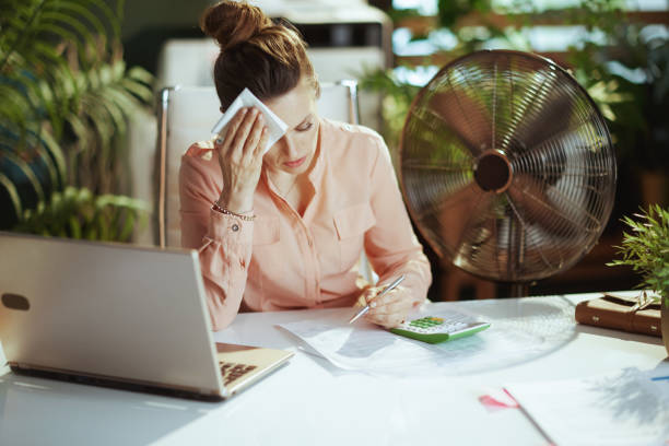 istock female worker in green office suffer from heat 1490703495