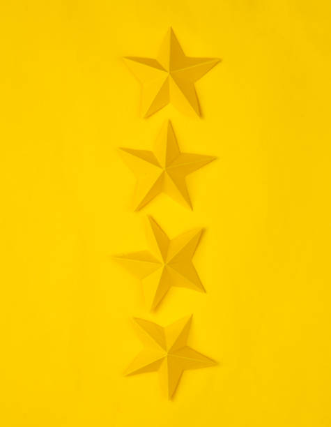 istock Four paper stars on yellow background. Service rating 1490706937