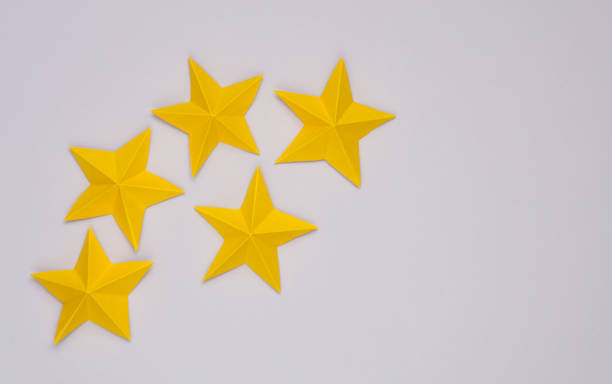 istock Five paper stars on gray background. Service rating 1490706944