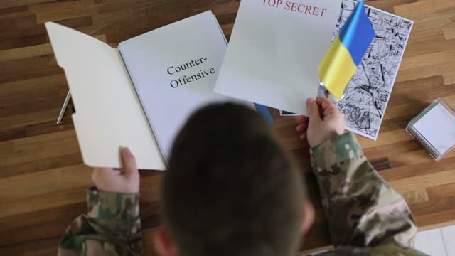 Ukrainian military studying document top secret counteroffensive closeup 4k movie slow motion