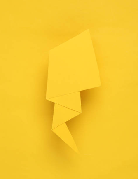 istock Yellow paper speech bubble on a yellow background 1490707606