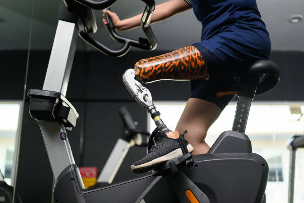 istock Disabled athlete patient with prosthetic leg doing exercise at gym 1490708471