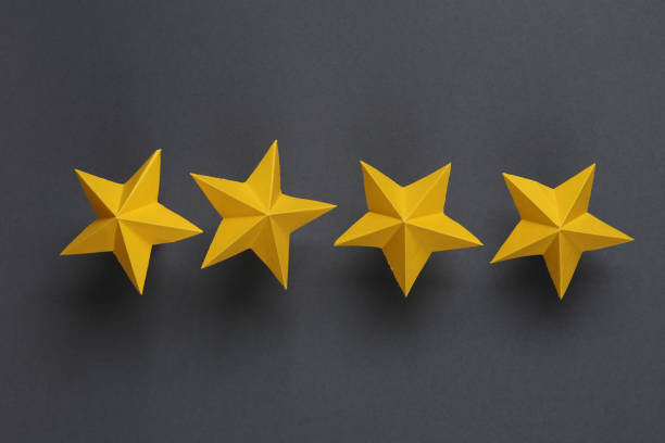 istock Four paper stars on gray background. Service rating 1490708500