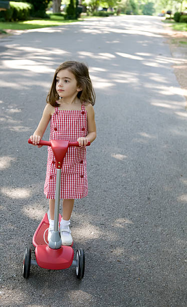 Little Girl on Scooter stock photo