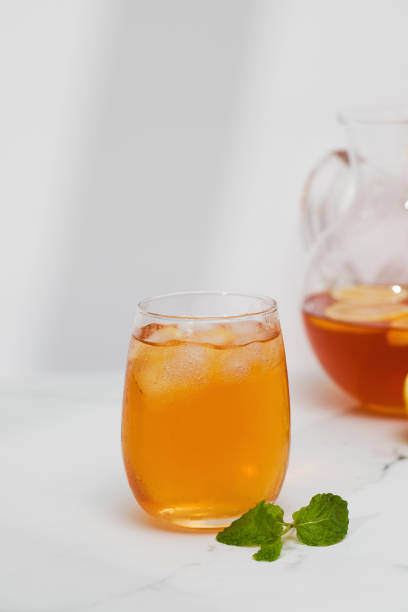 istock Iced tea with lemon and mint in a glass and in a jug. Summer drinks. 1490709200