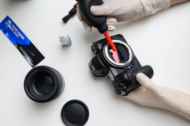 istock Cleaning the camera sensor with a blower for office equipment and electronics from contamination 1490709402