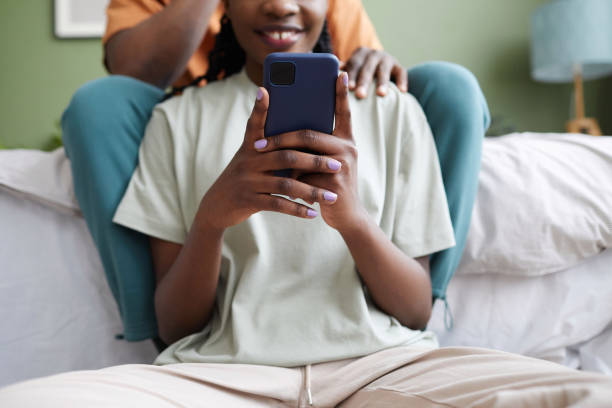 istock Woman using smartphone sitting in bedroom 1490709445