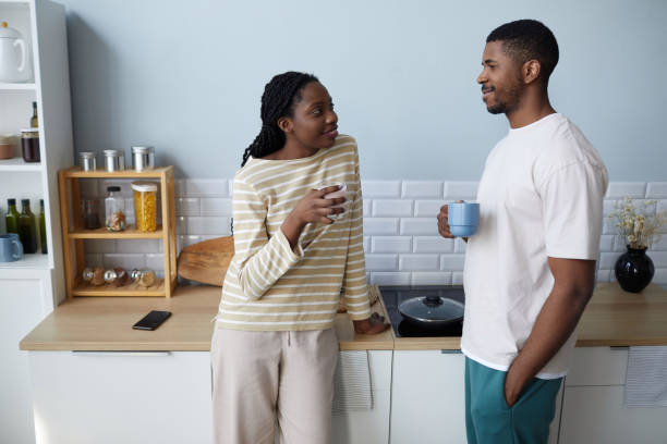 istock Couple drinking coffee together in the kitchen 1490709472