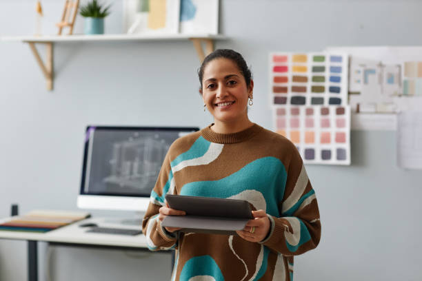 Female designer working online on digital tablet