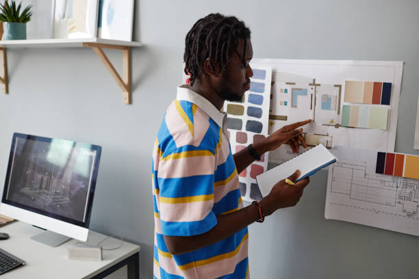 istock Designer examining blueprint on the wall 1490710114