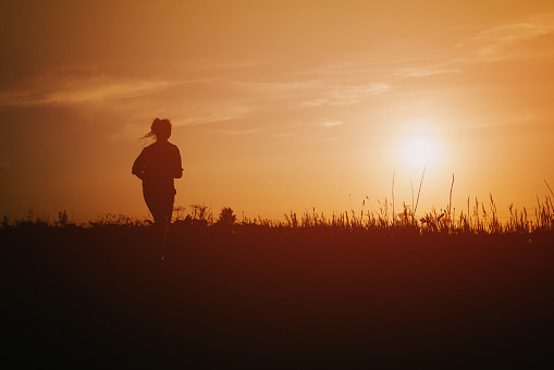 teenage girl runner countryside in sunset, sport photo with copy space