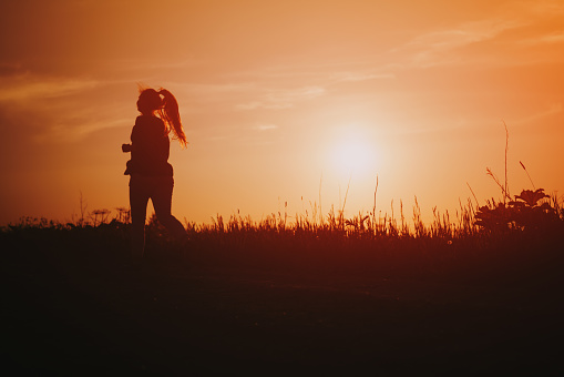 teenage girl runner countryside in sunset, sport photo with copy space