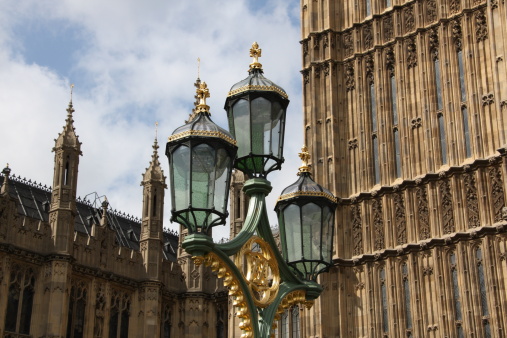 An ornate lamp post next to Big Ben and Parliament