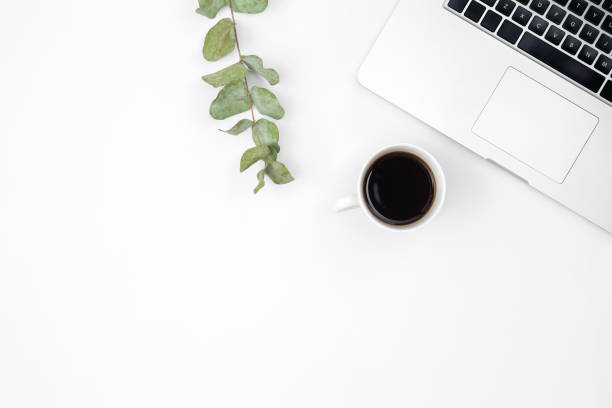 istock Laptop and a cup of black coffee on a white background, top view. 1490710953
