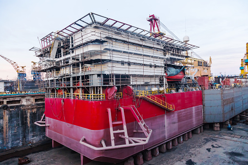 Construction of the hull of a new ship in dry dock at the shipyard in Constanta, Romania.