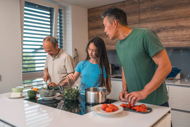 istock Cheerful Asian Family Spending Time Together In A Kitchen 1490711326