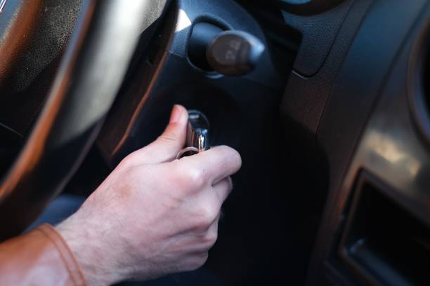 istock Hand's man plug in key, starting the engine of car 1490711337