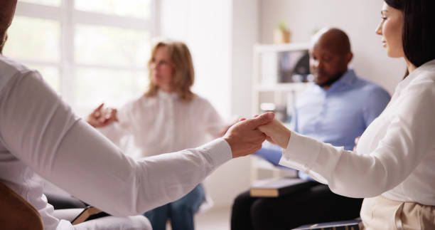 istock Group Of People Sitting Together Praying 1490711408