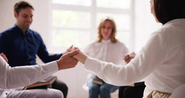 istock Group Of People Sitting Together Praying 1490711416