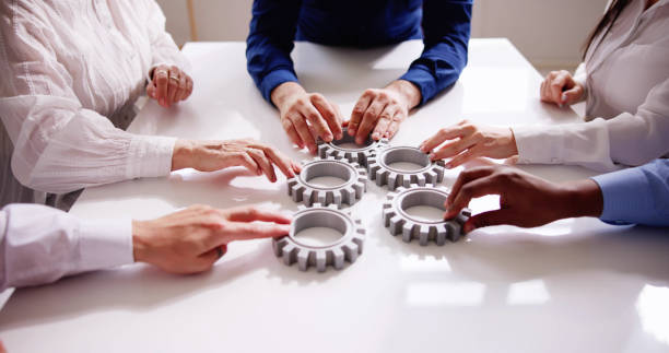 istock Diverse People Hands Holding Gear Wheels 1490711490