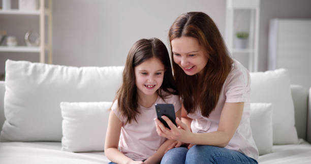 istock Woman Texting On Phone With Child 1490711636