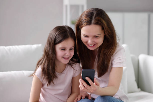 istock Woman Texting On Phone With Child 1490711640