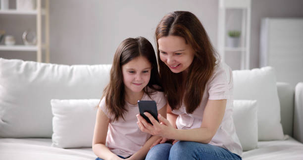 istock Woman Texting On Phone With Child 1490711657
