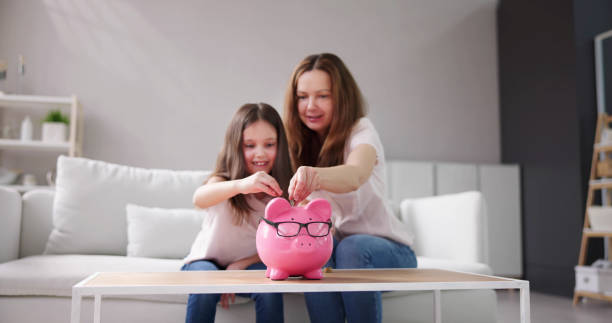 istock Mother And Child Saving Money 1490711668