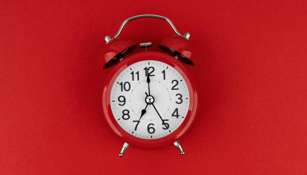 istock Red alarm clock on a red background. Top view. 1490711970
