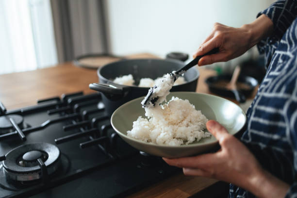 Anonymous Woman Preparing Rice at Home